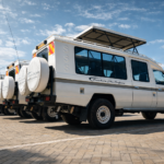 Safari vehicles under the bright sky